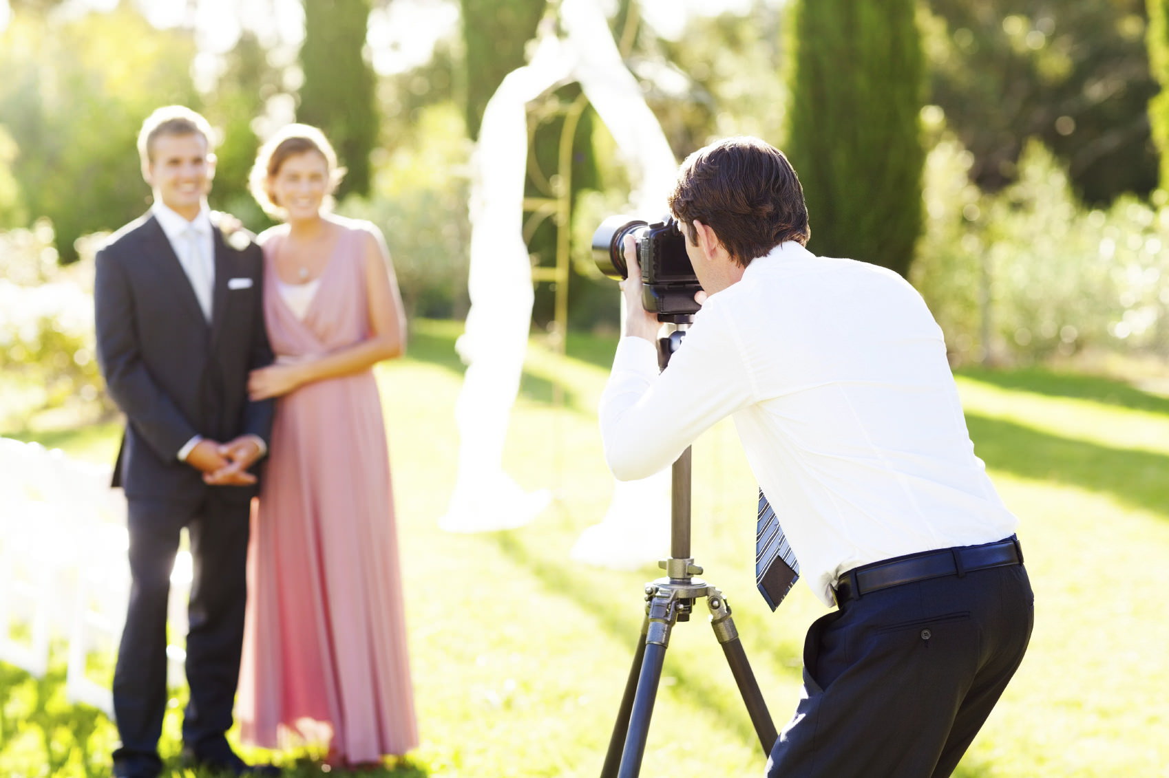 wedding photographer taking pictures of bride and groom